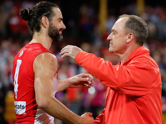 SYDNEY, AUSTRALIA - SEPTEMBER 20: Brodie Grundy of the Swans and John Longmire, Senior Coach of the Swans are seen during the 2024 AFL First Preliminary Final match between the Sydney Swans and the Port Adelaide Power at The Sydney Cricket Ground on September 20, 2024 in Sydney, Australia. (Photo by Dylan Burns/AFL Photos via Getty Images)