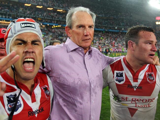 Coach Wayne Bennett celebrates with Jamie Soward (left) and Dean Young after the final siren.