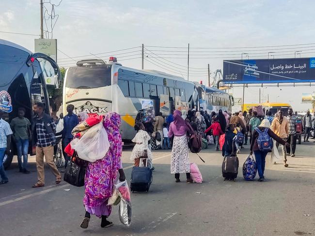 People displaced by conflict prepare to board a bus from Port Sudan in northeastern Sudan on January 7, 2025 to return home to the southern city of Singah in Sennar province, which was retaken by the Sudanese army forces from the Rapid Support Forces (RSF) in November 2024. (Photo by AFP)