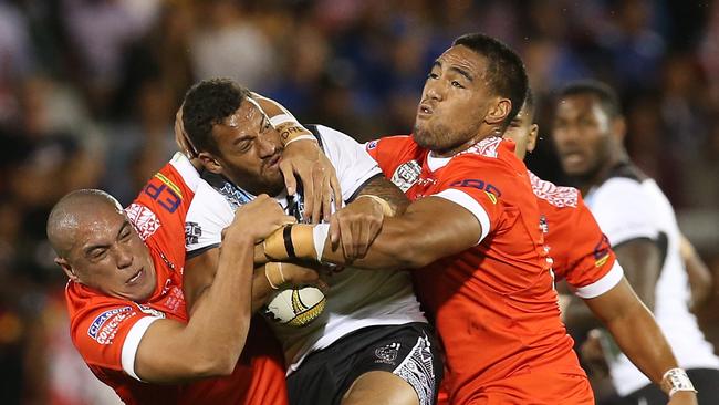 Daniel Saifiti of Fiji tries to fight through the Tongan defence.