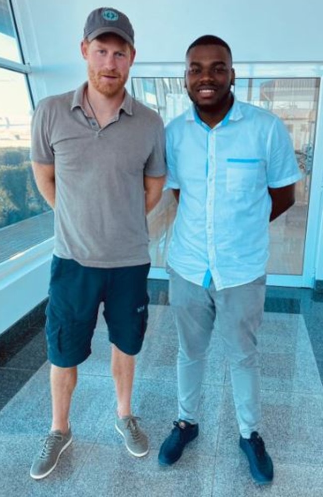 Prince Harry posing with an unnamed man in Mozambique.