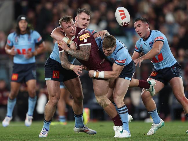 SYDNEY, AUSTRALIA - JUNE 05: J'maine Hopgood of the Maroons is tackled during game one of the 2024 Men's State of Origin Series between New South Wales Blues and Queensland Maroons at Accor Stadium on June 05, 2024 in Sydney, Australia. (Photo by Matt King/Getty Images)