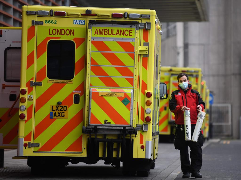 A paramedic replaces oxygen canisters as hospitals report record numbers of patients. Picture: Daniel Leal-Olivas /AFP