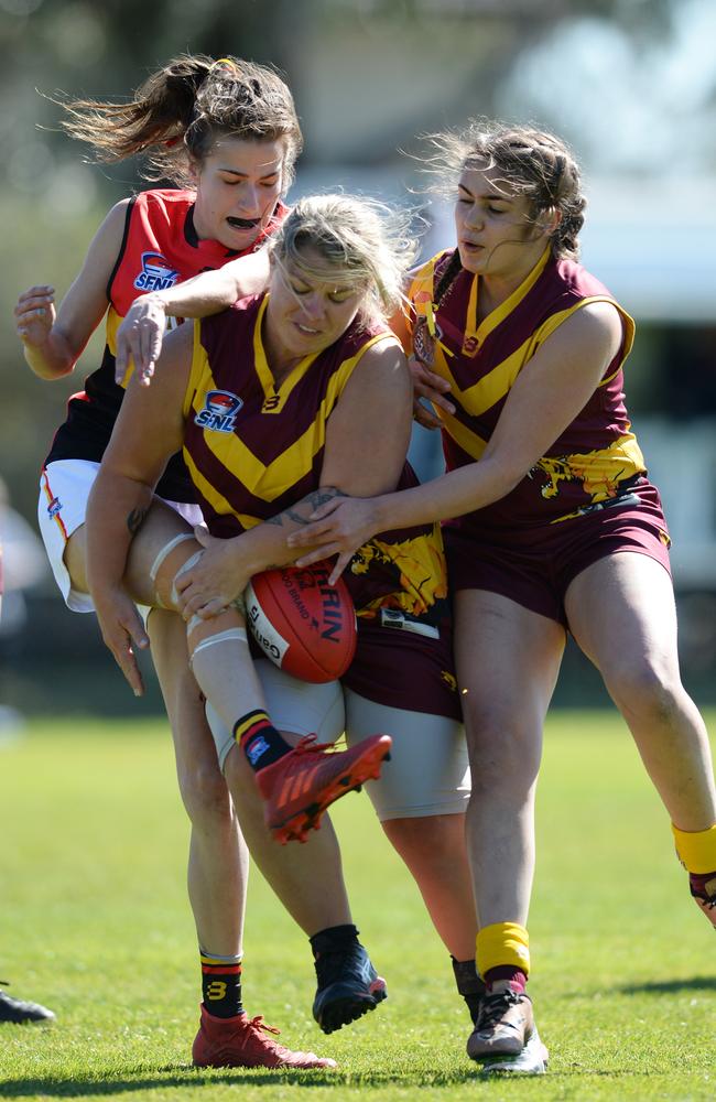 Hallam’s Skye O'Keefe is tackled by Pumas Jess McDonald and Jade Lyons as she takes her kick. Picture: AAP/ Chris Eastman