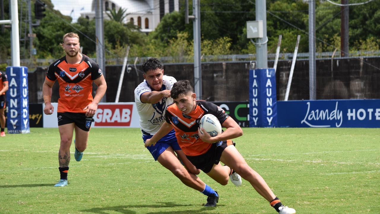 Levi Conti is tackled by Kallum Weatherall-Stacey in the SG Ball Cup, Belmore Oval, 25 February 2023