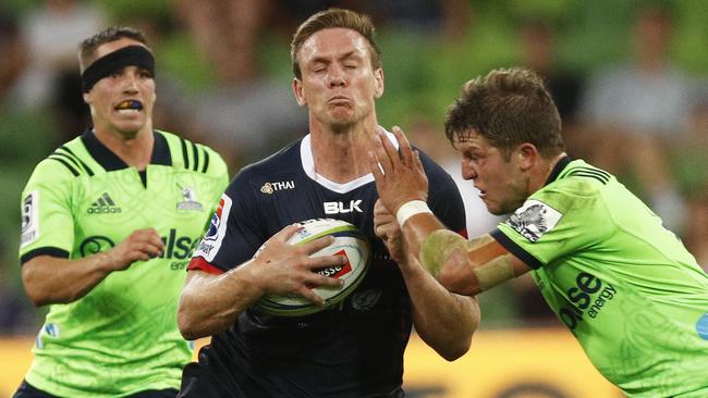 Dane Haylett-Petty of the Rebels looks to get past Teihorangi Walden of the Highlanders on Friday night. Picture: AAP