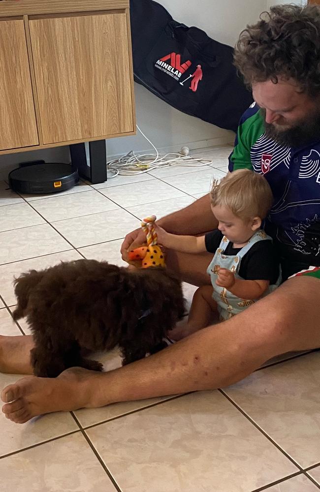 Parker and his dad playing with his new puppy, Rusty.