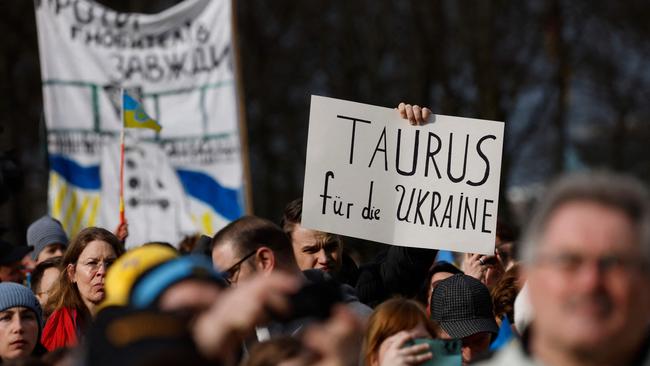 A demonstrator holds up a placard calling on the German government to supply Ukraine with Taurus air-to-surface cruise missiles, during a rally in support of Ukraine. Picture: AFP