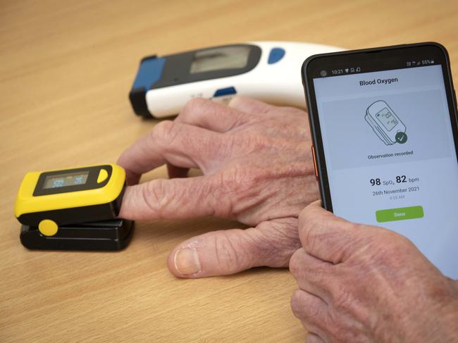 Mobile phone with My Health Care Manager app installed, digital thermometer and oximeter.. Picture: Chris Kidd