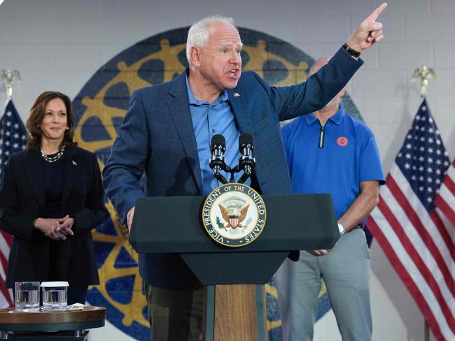 Democratic vice presidential candidate Minnesota Gov. Tim Walz (C) speaks as Democratic presidential candidate U.S. Vice President Kamala Harris (L) looks on at a campaign rally at United Auto Workers Local 900 on August 8, 2024 in Wayne, Michigan. (Photo by Andrew Harnik / GETTY IMAGES NORTH AMERICA / Getty Images via AFP)