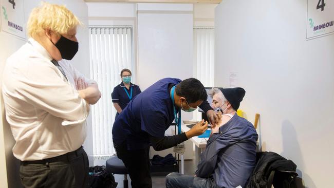 British Prime Minister Boris Johnson visits a Covid-19 vaccination centre during the week. Cabinet ministers are still lauding Mr Johnson for his decision not to impose coronavirus restrictions over Christmas and the new year. Picture: Pool / AFP