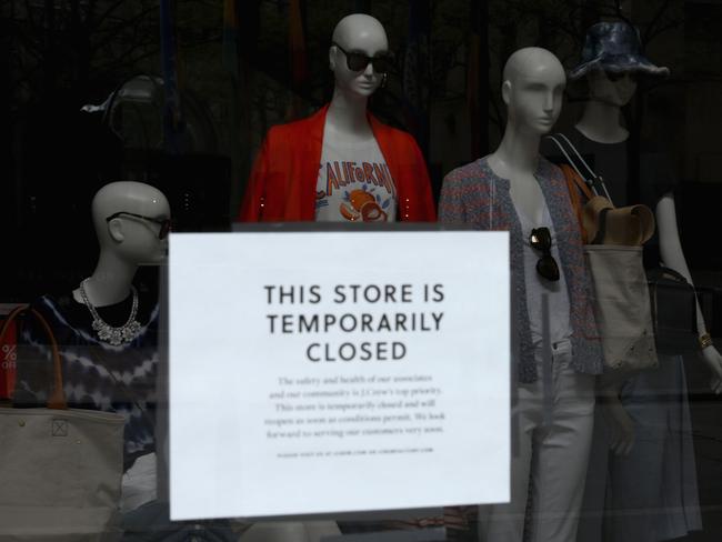 A sign in the window of a closed J.Crew store in New York. Picture: AFP