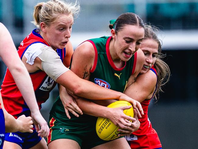 Tasmania Devils pathway player Perri King is tackled by two Port Melbourne players at UTAS Stadium, Launceston. Picture: Linda Higginson/Solstice Digital