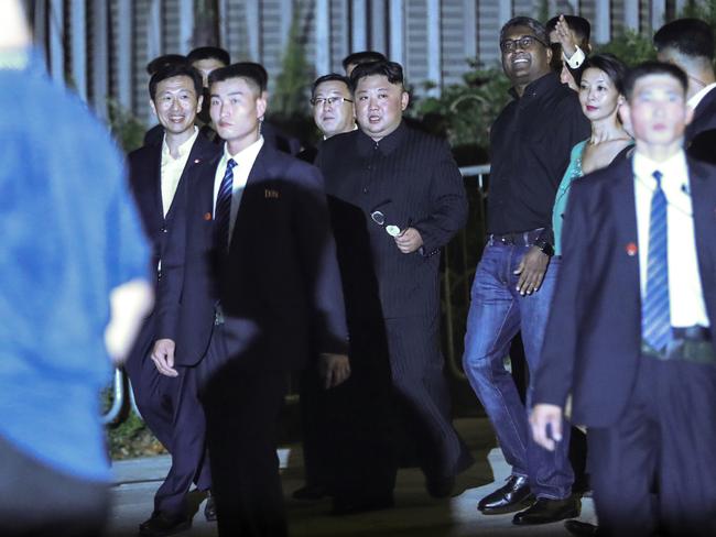 Kim Jong-un is surrounded by security as he walked through Singapore’s Marina Bay. Picture: AP