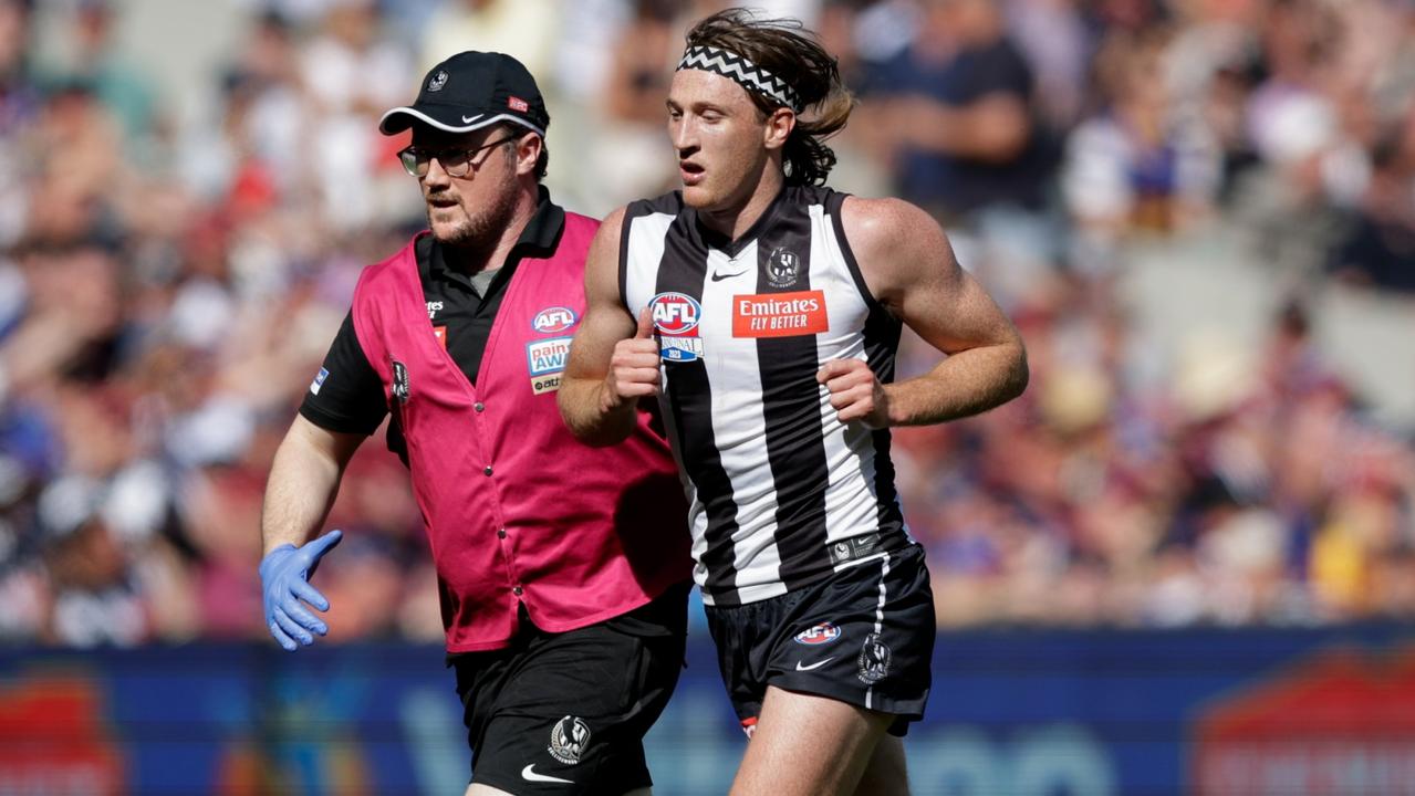 MELBOURNE, AUSTRALIA - SEPTEMBER 30: Nathan Murphy of the Magpies leaves the ground in the hands of a trainer during the 2023 AFL Grand Final match between the Collingwood Magpies and the Brisbane Lions at the Melbourne Cricket Ground on September 30, 2023 in Melbourne, Australia. (Photo by Russell Freeman/AFL Photos via Getty Images)