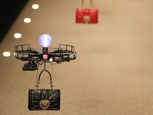 Drones carry handbags as part of the Dolce & Gabbana women's Fall/Winter 2018-2019 collection, presented during the Milan Fashion Week, in Milan, Italy, Sunday, Feb. 25, 2018. (AP Photo/Antonio Calanni)