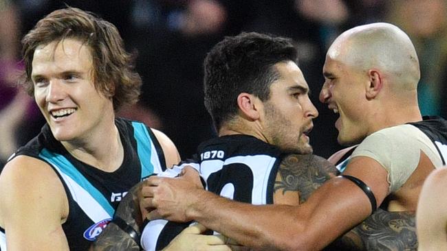 Jared Polec, Chad Wingard and Sam Powell-Pepper celebrate a goal for the Power. Picture: AAP Image/David Mariuz