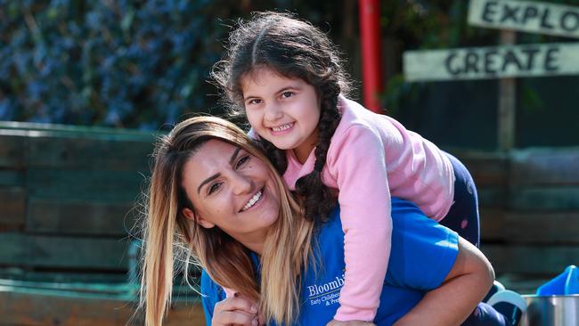 Chrissanthy Tsigolis with Mariella Sahda ,4, at her childcare centre, Bloombirds, in Rosebery, today. She has decided to cut down prices from $120 to as low as $75 to ensure parents were able to afford keeping their children there. Picture:Justin Lloyd.