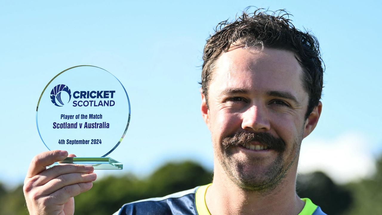 Australia's Travis Head celebrates with the players of the match trophy at the end of the first Twenty20 International cricket match between Scotland and Australia at the Grange Cricket Club in Edinburgh, Scotland, on September 4, 2024. Australia wins against Scotland. (Photo by ANDY BUCHANAN / AFP)