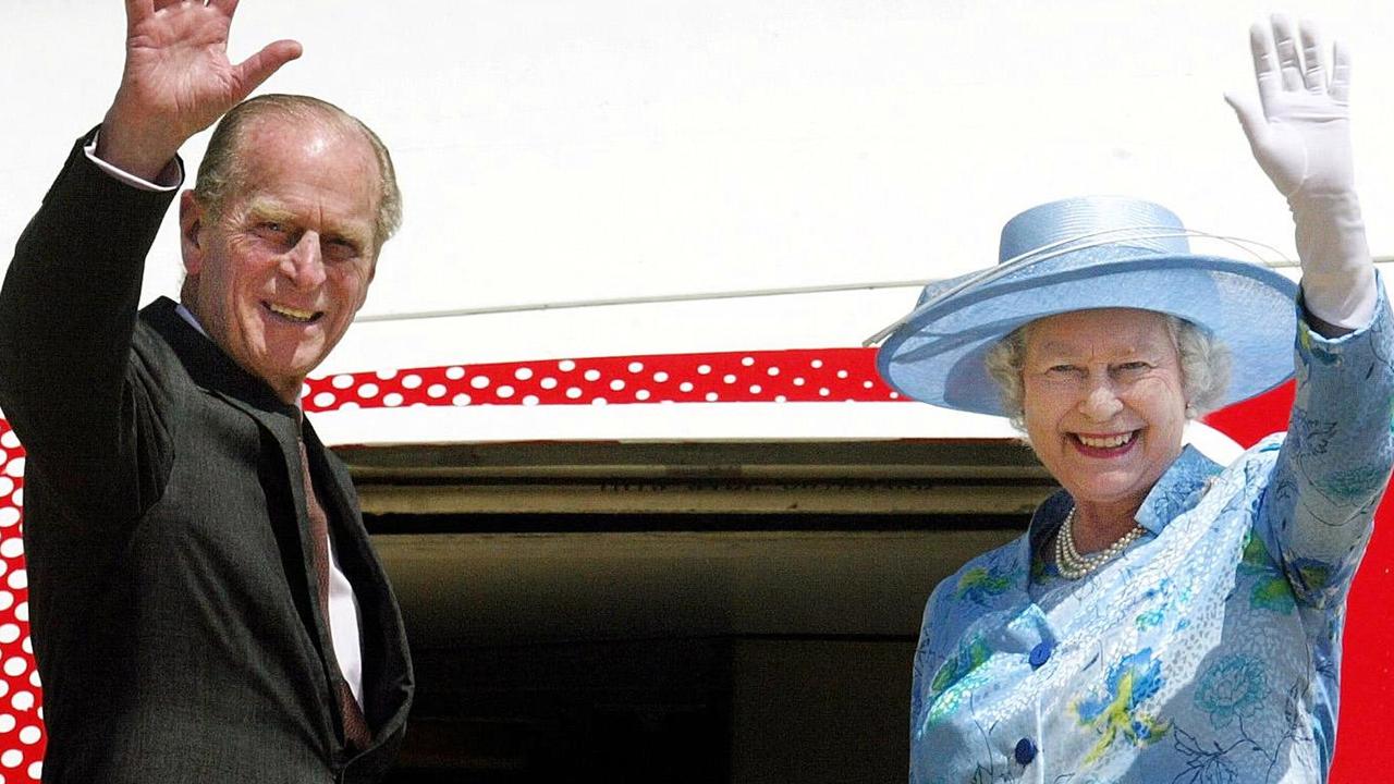 The Queen and Prince Philip wave goodbye as they depart Nigeria. Picture: AFP