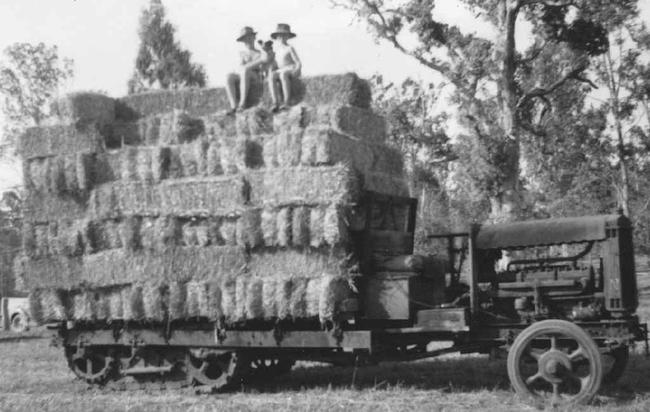 EARLY DAYS: John and Eric Scott in the mid 1950s, sitting atop a load of hay on the same Linn tractor that they still use on the farm today. Picture: Contributed