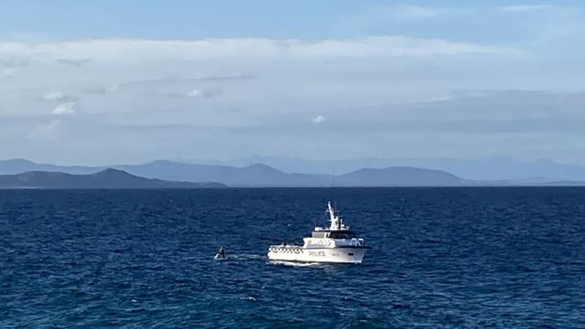 A police vessel and jet skis assist in the search at Laggers Point