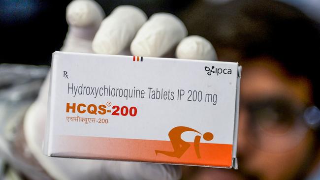 This photo taken on April 28, 2020 shows a pharmacist displaying a box of hydroxychloroquine (HCQ) tablets in his store in Hyderabad. - India has ramped up output of an anti-malarial drug hailed by US President Donald Trump as a "game-changer" in the fight against coronavirus, even as its pharmaceutical industry struggles to make other key medicines in a lockdown. (Photo by NOAH SEELAM / AFP) / TO GO WITH AFP STORY health-virus-India-pharmaceutical by Bhuvan Bagga and Vishal Manve