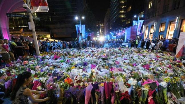 Mourners gather at Martin Place amid a sea of flowers / Picture: Richard Dobson