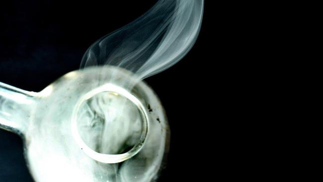 Methamphetamine pure crystals being heated in a glass pipe.