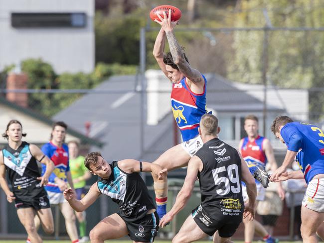 Huonville’s Mitchell Walker reaches high for a mark. Picture: Chris Kidd