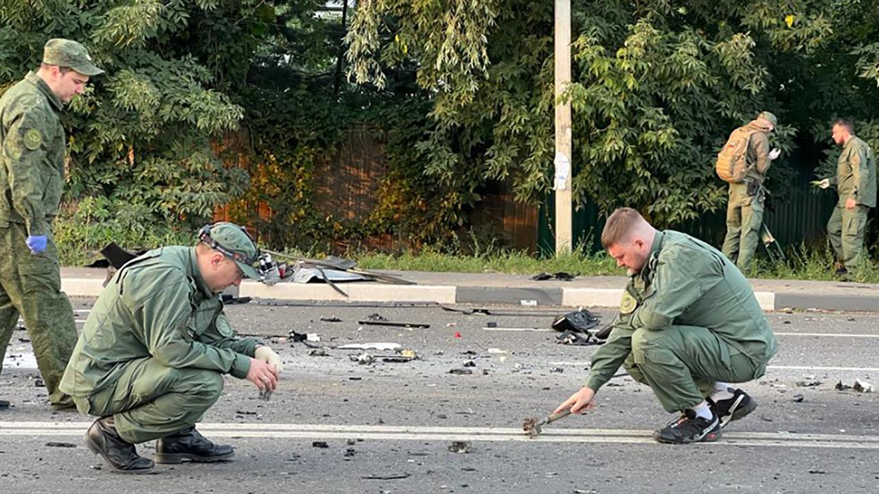 Investigators collect evidence at the scene of the blast that killed Darya Dugina. Picture: Handout/Investigative Committee of Russia/AFP