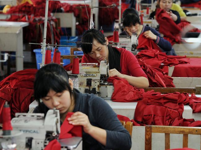 Chinese workers stitch various clothes for export to Europe at a textile factory in Hefei, in eastern China's Anhui province on October 12, 2010. China's trade surplus shrank in September as growth in exports and imports slowed sharply, official data showed on October 13, but the decline was unlikely to ease pressure on Beijing for a stronger yuan.      CHINA OUT         AFP PHOTO