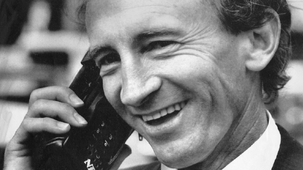 Jockey Mick Dittman telephoning trainer Bob Hoystead on his mobile phone. November 1990.                             
Communications / Telephones                     
Sport / Turf / Head