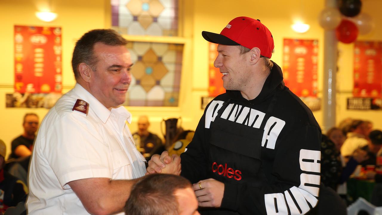 Collingwood's Jordan De Goey shakes hands with Salvation Army Major Brendan Nottle at the Salvos footy finals lunch in Bourke St headquarters. Picture: Michael Klein