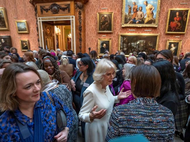 Britain's Queen Consort Camilla (C) speaks to guests near Ngozi Fulani (back C-L), chief executive of the London-based Sistah Space group, during a reception to raise awareness of violence against women and girls.