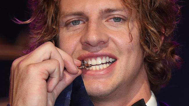 Brownlow Medal at Crown Casino, Melbourne. 23/09/2019.   Winner fremantles Nat Fyfe bites the Brownlow Medal   . Pic: Michael Klein.