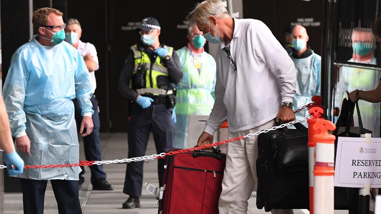 Travellers arrive at a hotel after returning from overseas.