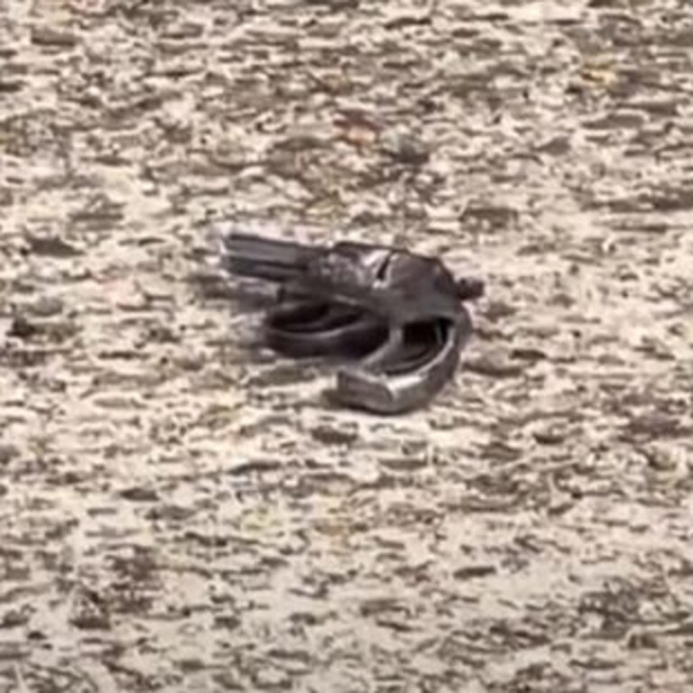 A gun seen on the ground close to where the incident allegedly took place.