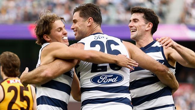 MELBOURNE, AUSTRALIA - APRIL 01: (L-R) Jhye Clark, Tom Hawkins and Mark O'Connor of the Cats celebrate during the 2024 AFL Round 03 match between the Hawthorn Hawks and the Geelong Cats at the Melbourne Cricket Ground on April 01, 2024 in Melbourne, Australia. (Photo by Michael Willson/AFL Photos via Getty Images)