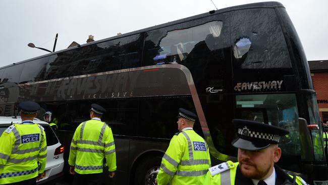 The bus carrying the Manchester United team is escorted by police after having a window smashed on its way to West Ham's Boleyn ground before the English Premier League football match between West Ham United and Manchester United in in east London on May 10, 2016. / AFP PHOTO / GLYN KIRK