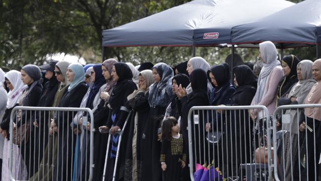 Mourners react as the bodies of two victims are carried to their resting places. Picture: Mark Baker/AP