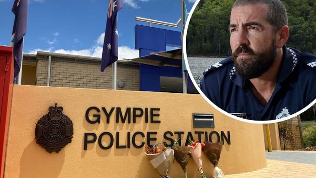 Imbil police station officer in charge Sergeant Bill Greer (inset) has opened up about the horrific events at Wiembilla where two officers and a civilian were murdered in cold blood, while Gympie's police station is flying flags at half mast and bouquets have been placed outside.