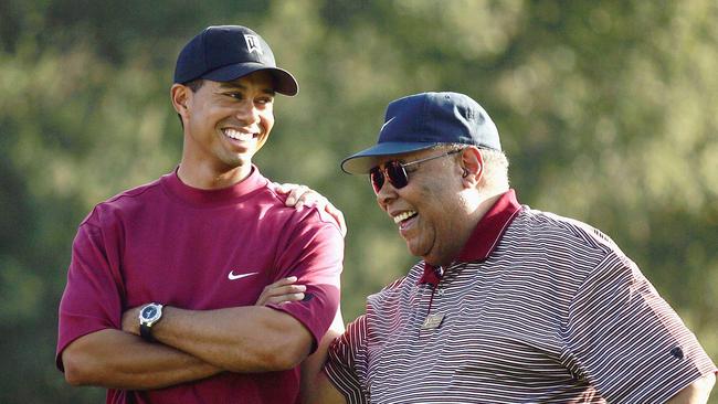 Tiger Woods (L) smiles as he stands with his father, Earl Woods, during the trophy presentation of the Target World Challenge on December 12, 2004 at Sherwood Country Club in Thousand Oaks, California. Picture: Doug Benc.