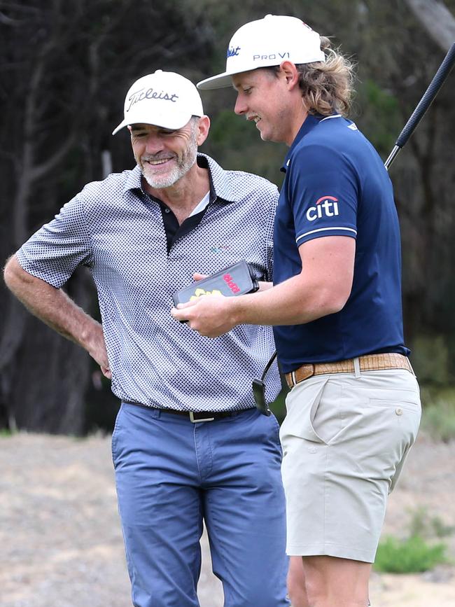 The pair discuss golfing strategy. Picture: Dean Martin