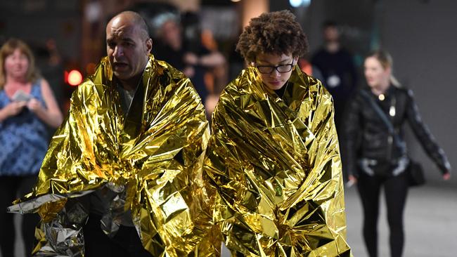 Members of the public wrapped in emergency blankets leave the scene of a terror attack on London Bridge. Picture: AFP/Chris J Ratcliffe