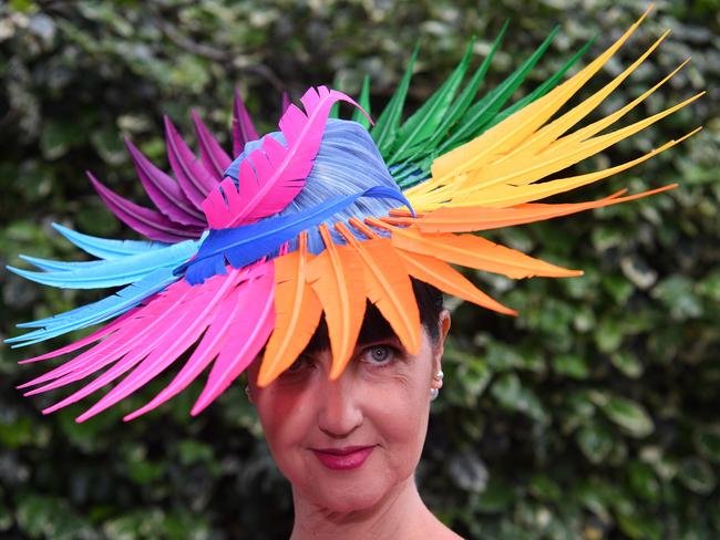 A woman dons a flamboyant headpiece made of colourful feathers. Picture:AAP Image/Joe Castro