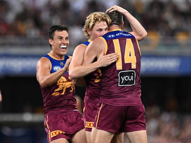 Sam Day (14) is congratulated by Brisbane teammates Levi Ashcroft and Hugh McCluggage (right) after kicking a goal. Picture: Bradley Kanaris/Getty Images