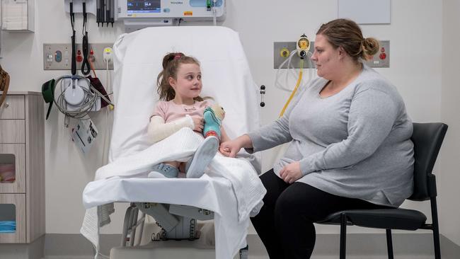 Lotti Bartley, 7, is joined by mum Monique after she hurt her arm at school. Picture: Jake Nowakowski