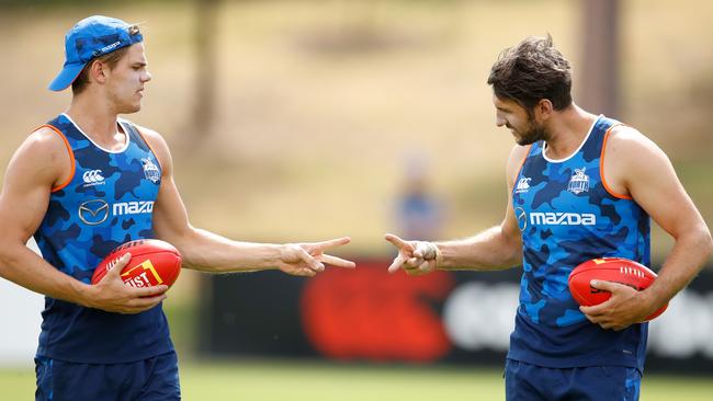 Jarrad Waite plays rock, paper, scissors with teammates Mason Wood at training.