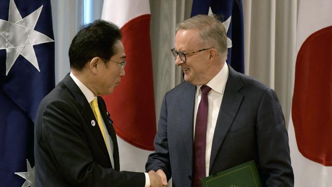 Japan's Prime Minister Fumio Kishida and Australian Prime Minister Anthony Albanese shake hands following a signing ceremony.